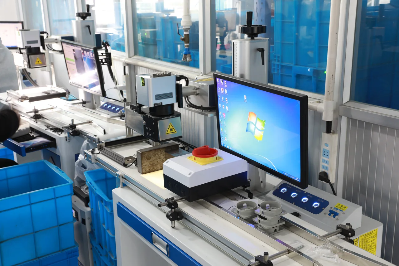 Laser marking workstation with a red and yellow rotary isolator switch enclosure